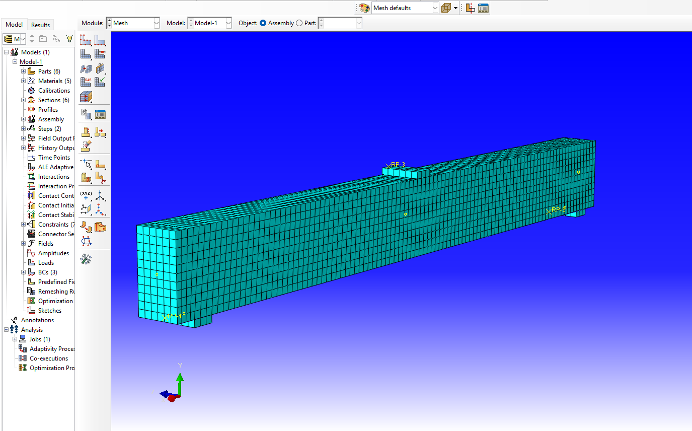 Finite element mesh in a reinforced concrete Abaqus model with local refinement in a critical response zone
